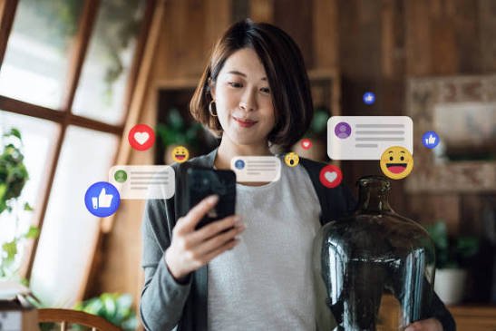 Woman looking at social media like and comment notifications on her phone