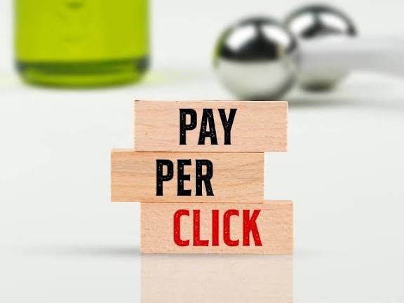 Wooden letter blocks spelling Pay Per Click on a desk