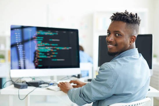 Web developer writing code on a desktop monitor
